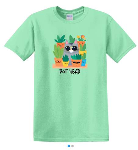 Flat lay of a green Pot Head shirt featuring a grey cat wearing sunglasses surrounded by planters with sunglasses and hidden cats.