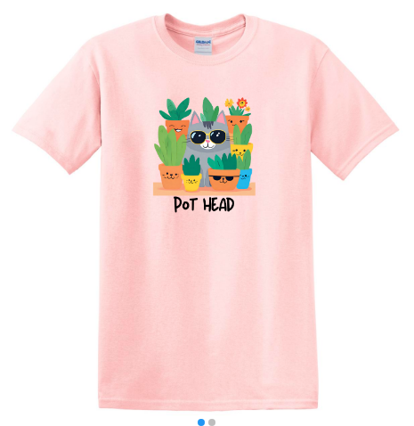 Flat lay of a pink Pot Head shirt featuring a grey cat wearing sunglasses surrounded by planters with sunglasses and hidden cats.